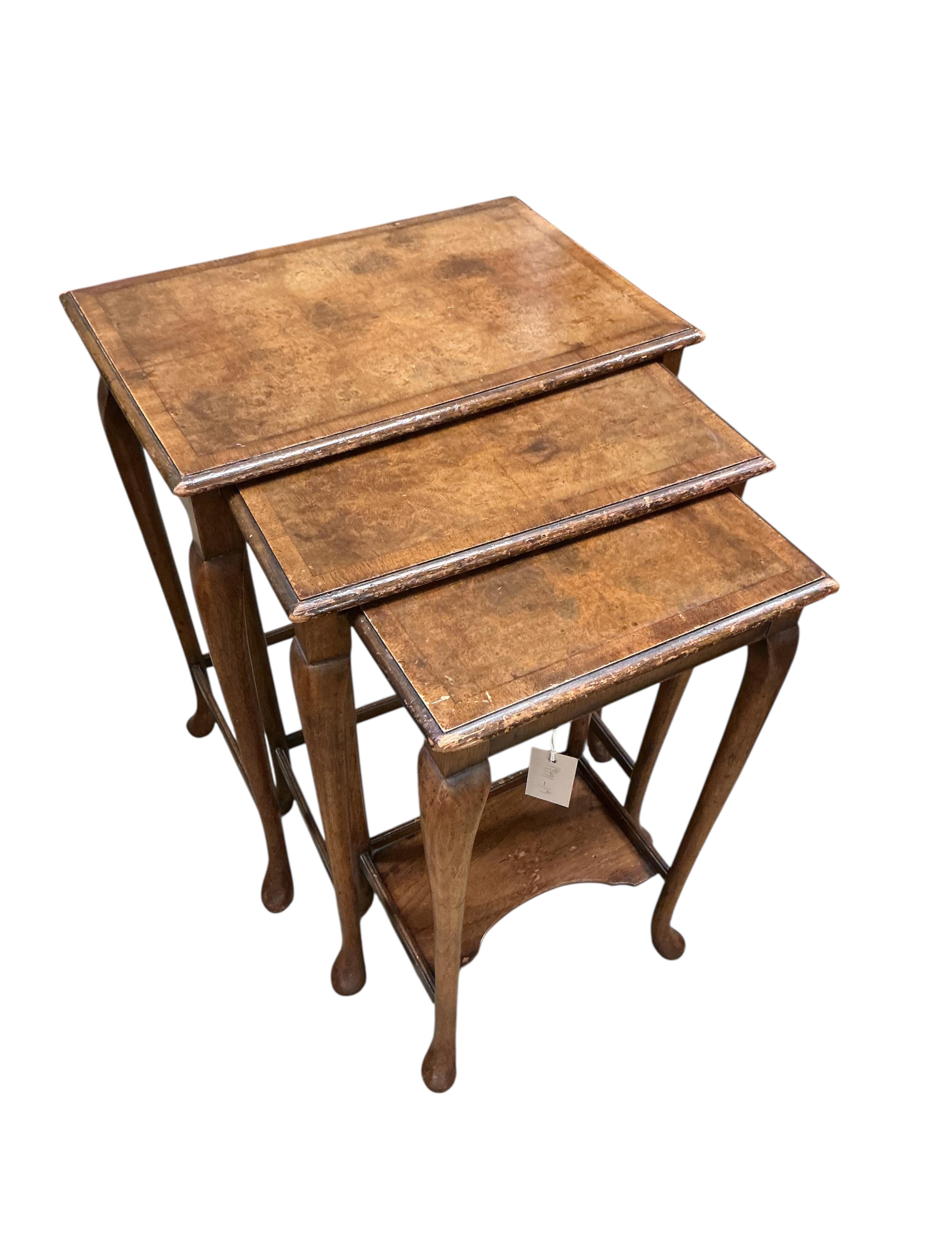 A Waring and Gillows nest of banded walnut tables, width 48cm, depth 32cm, height 60cm